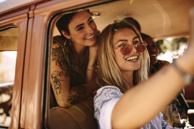 Women friends taking selfie on a road trip