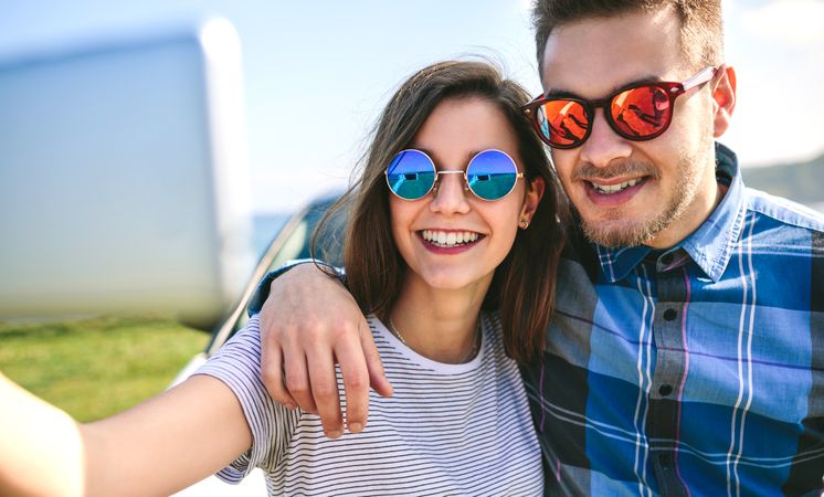 Young couple doing a selfie on the car