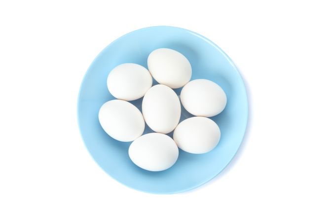 chicken eggs in plate isolated on plain background, top view