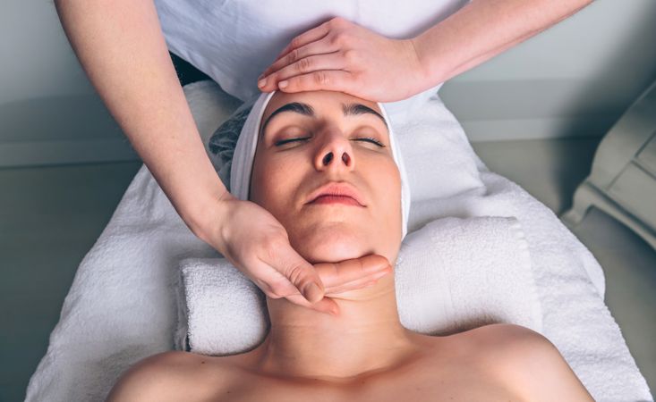 Female client receiving a relaxing facial treatment