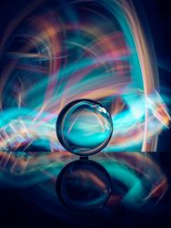 Crystal ball on board near abstract shines