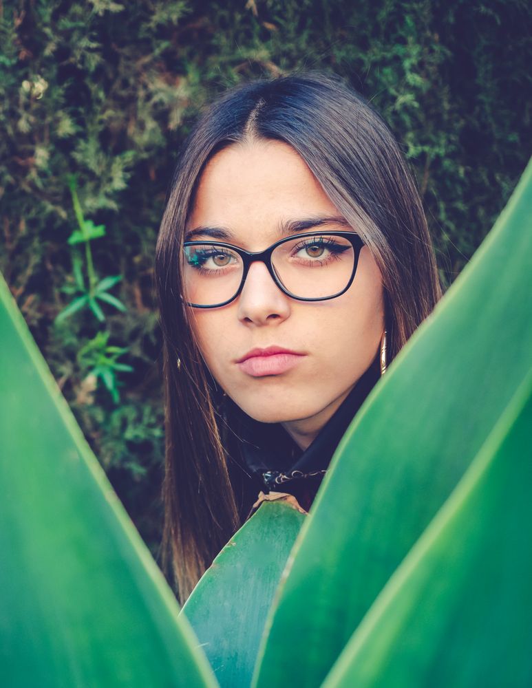 Woman between green leaves