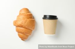 Flat lay of croissant and cup of coffee on plain background 0J1rnb