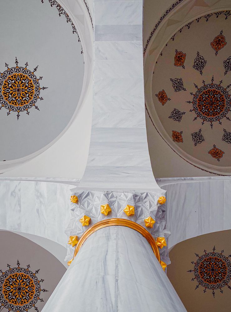 Looking directly up at decorated ceiling in a mosque