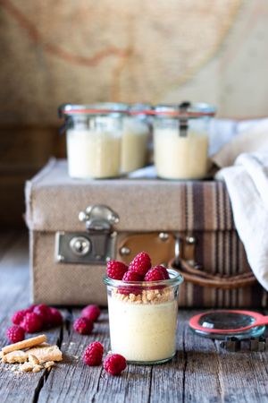 Cheesecake with raspberry in tubs on table