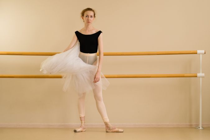 Ballet dancer in dance studio demonstrates artistry and grace.