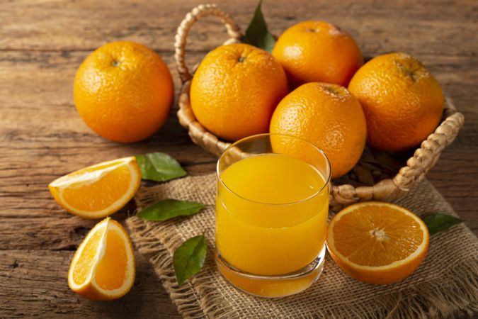 Glass with orange juice on the table.