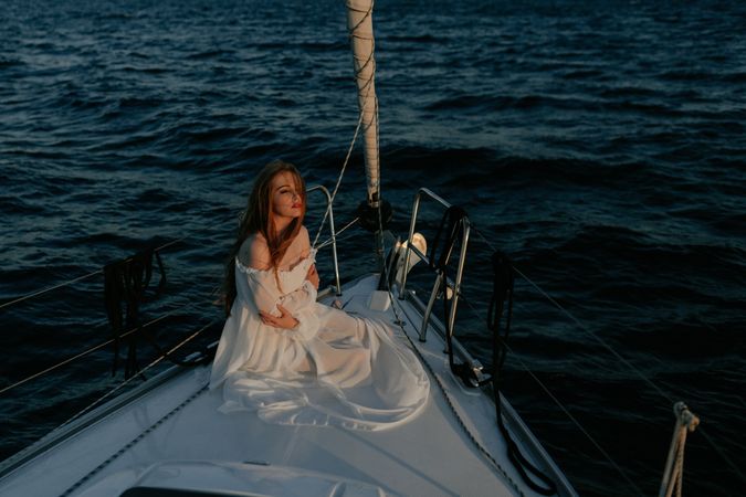 Woman in luxury dress resting on yacht