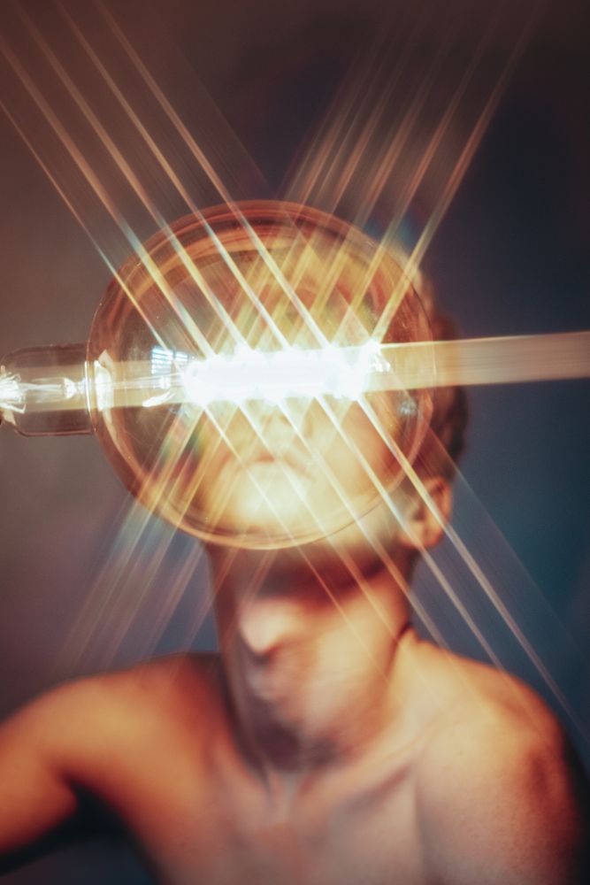Blurry light over topless young man's face