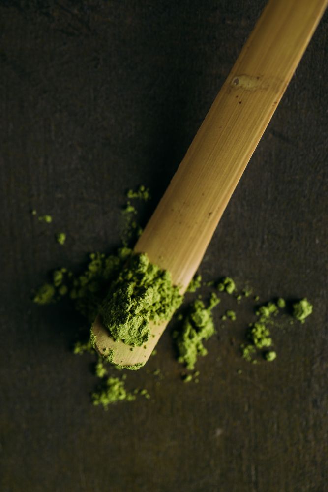 Green matcha tea powder and bamboo whisk