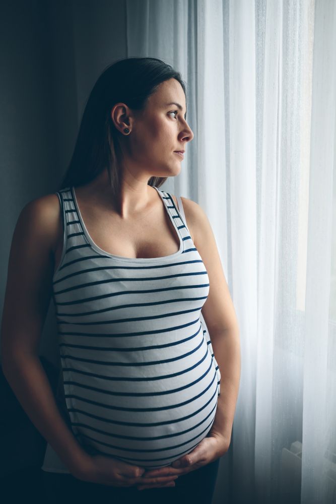 Pregnant woman holding her belly