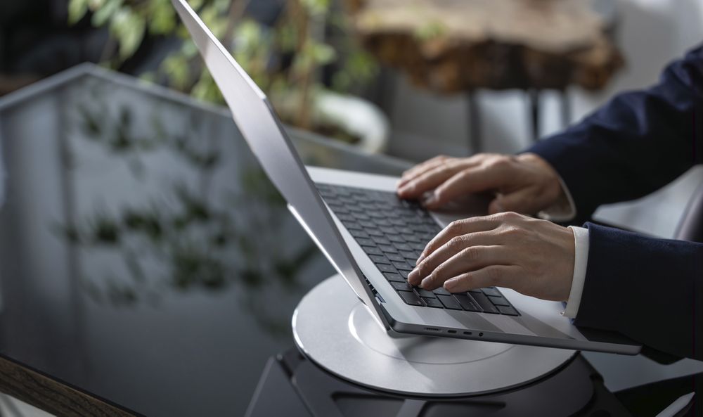 Businessman Working on Laptop at Office Desk