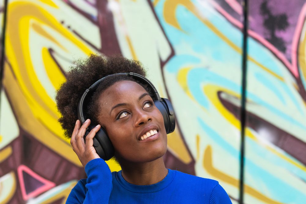Positive woman enjoying music in city