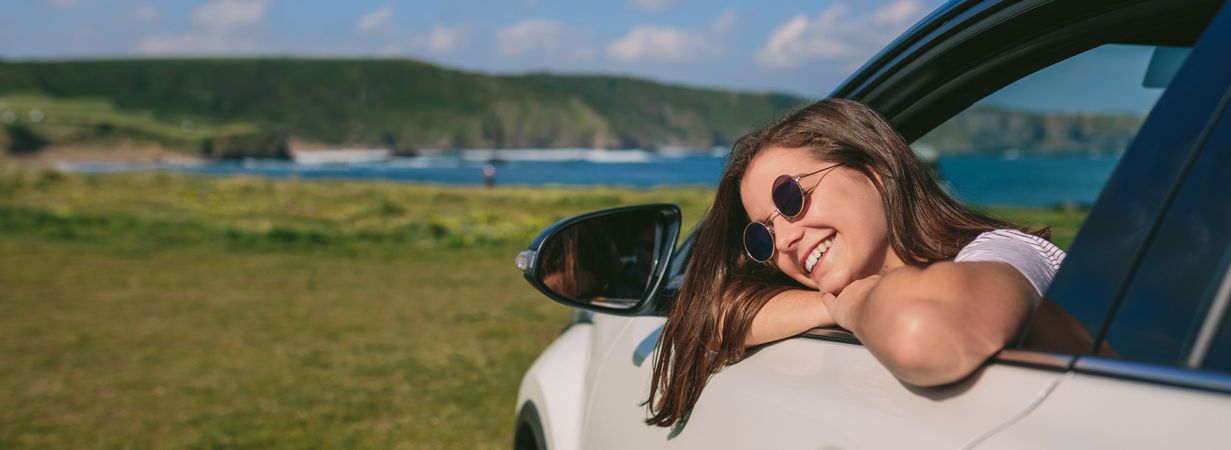 Woman leaning on window of the car