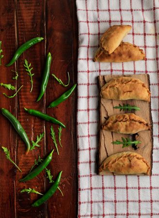 Set of patties between herbs and chili on napkin