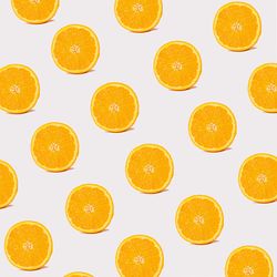 Pattern of orange slices on light background