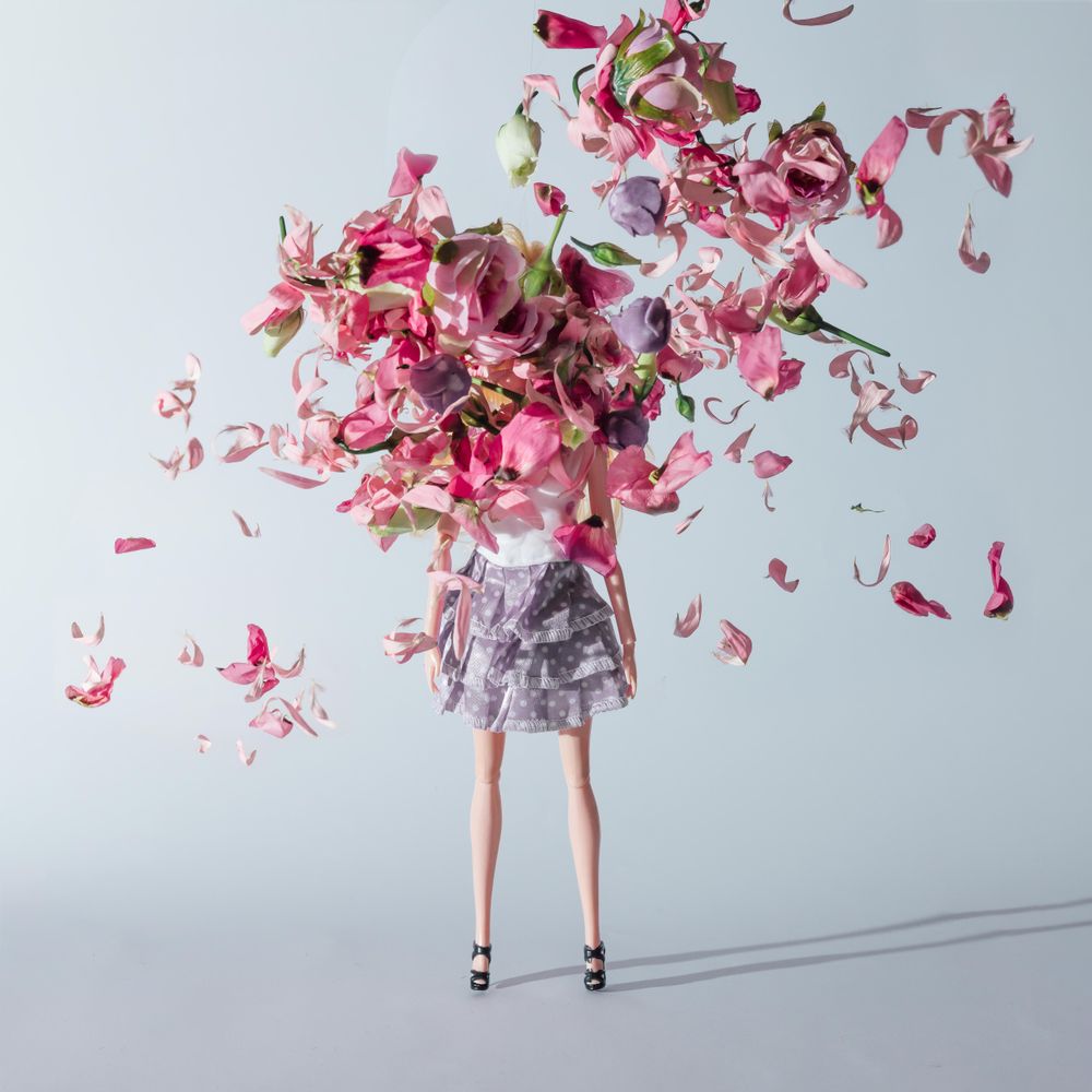 Doll in skirt with pink and violet flowers