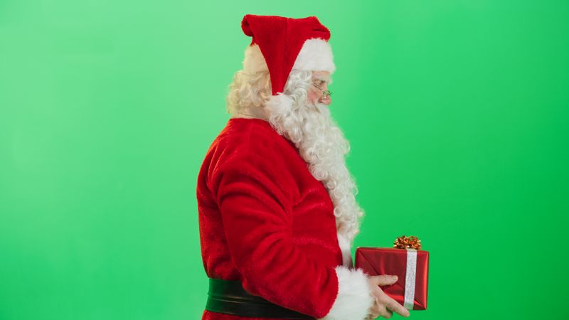 Studio Shot Isolated Mockup Template: Jolly Santa Claus Offering Beautifully Wrapped Gift To Children On Green Screen Chromakey Background. Concept Of Christmas, New Year, Celebration