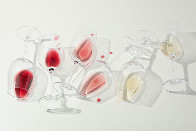 Flat lay composition. Glasses with different wine on blank background