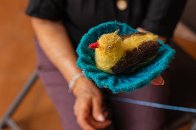 Older woman's knitting masterpiece.