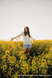 Woman standing on yellow flower field 56yPV0