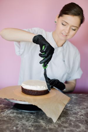 Female chef making a cake