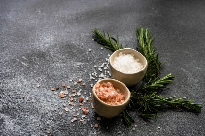 Salt bowls and rosemary on kitchen counter