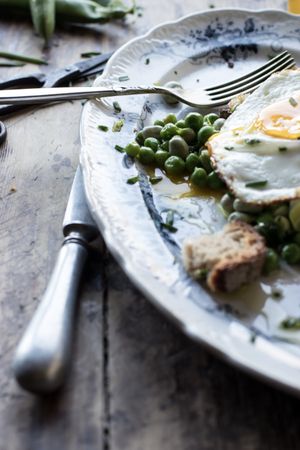 Delicious breakfast meal with steamed peas and egg