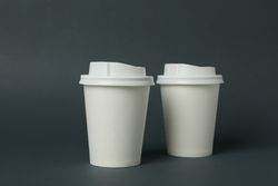 paper cups on light dark background, space for text