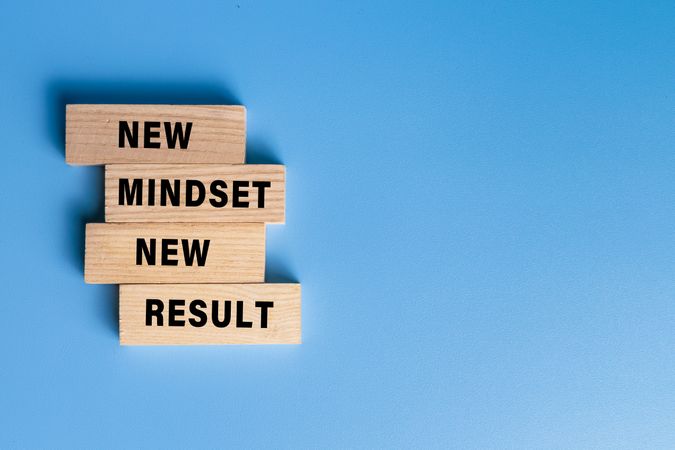 new mindset new result words text on wooden blocks isolated on blue background
