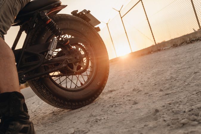 Male riding moto on asphalt