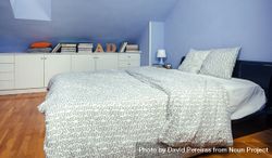 Bedroom in an attic with double bed with grey patterned duvet 0LdLpr
