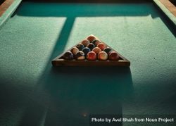 Looking down at triangle of pool table balls 4MjEEb