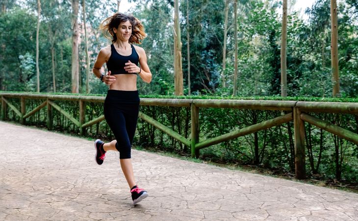 Woman running through a park