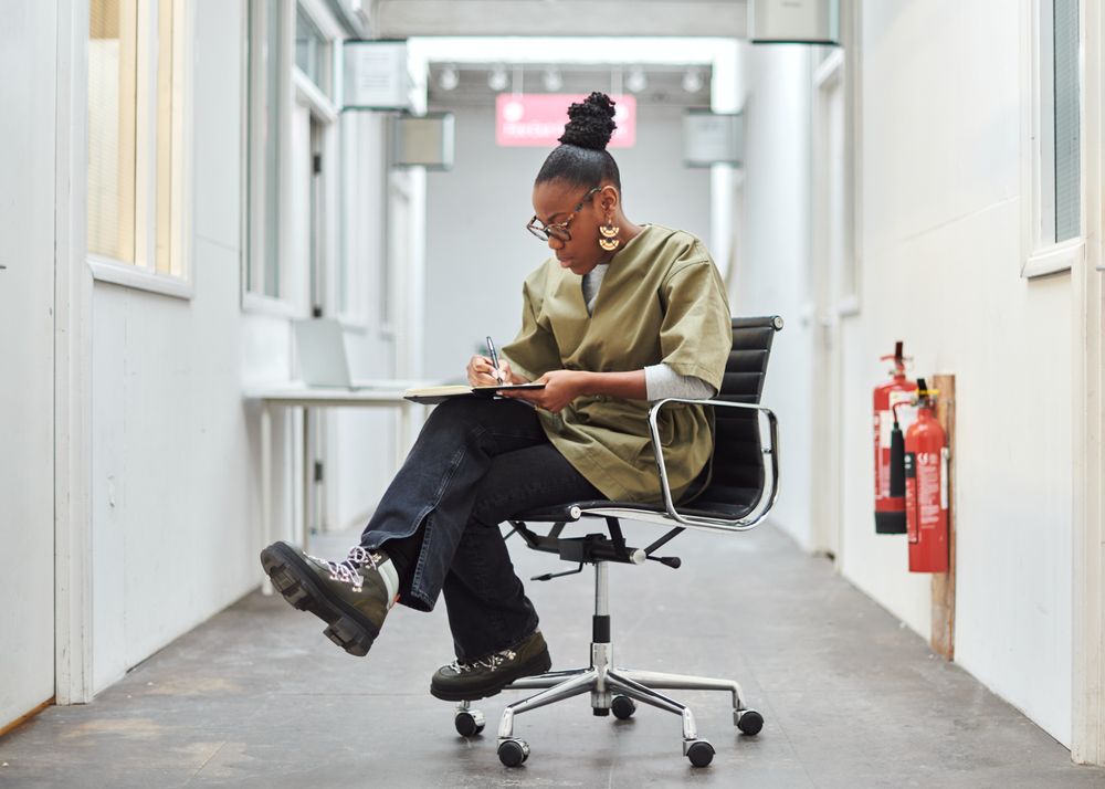 Woman on office chair in hallway