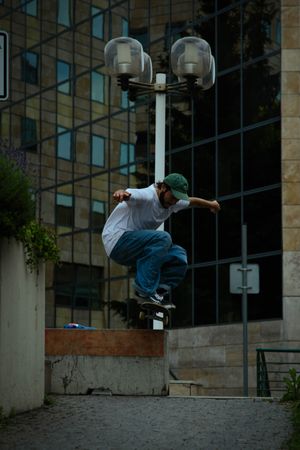 Man in light shirt skateboarding in the city