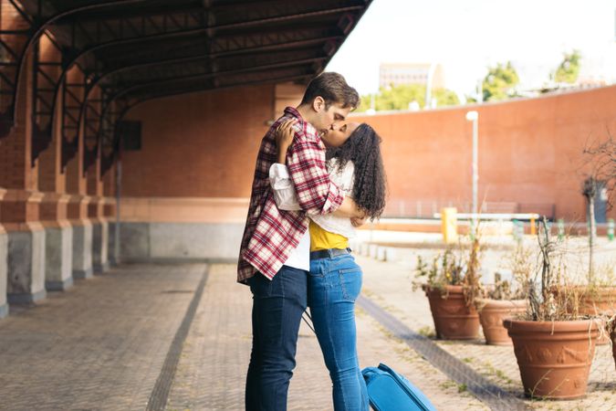 Young couple meeting at the station after a trip