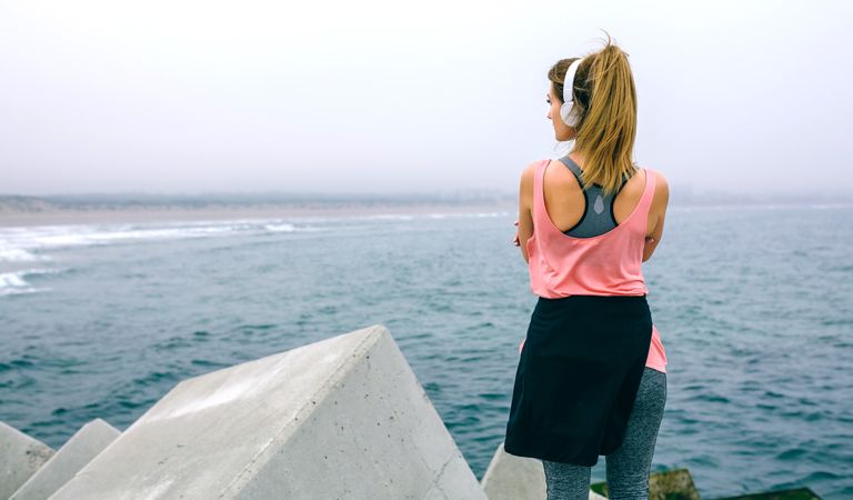 Back of woman standing on pier