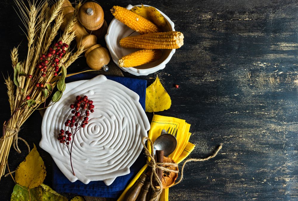Top view of textured porcelain birds plate with rustic autumnal decor, copy space