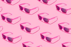 Pattern of pink sunglasses on blue background