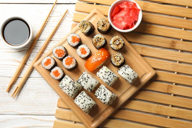 Composition with sushi rolls on wooden background, top view. Japanese food