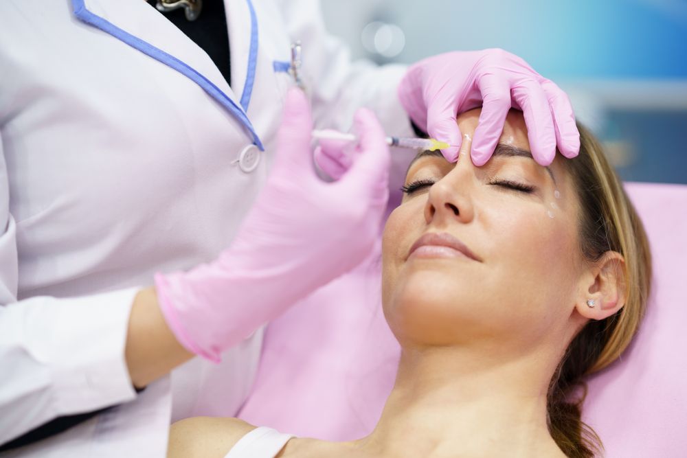 Woman having botox treatment on face in medical spa