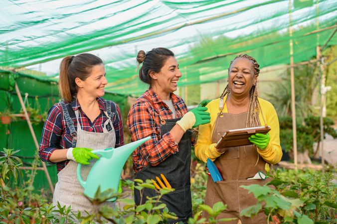 Cheerful diverse women in hothouse