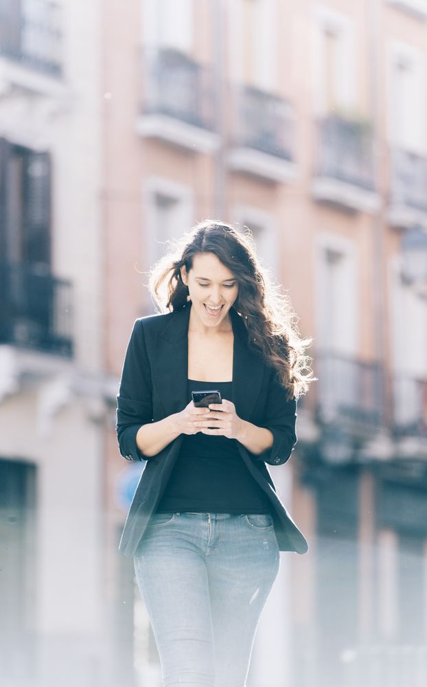 Young female walking with smartphone