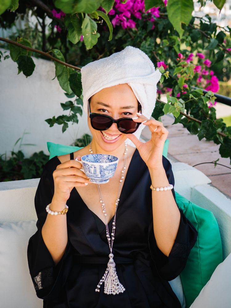 Chinese young rich woman having breakfast outdoors