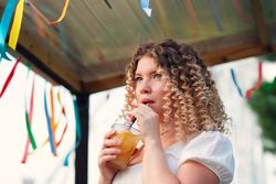 Woman with drink outdoors