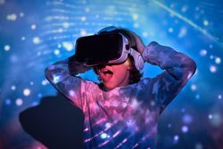 Shocked child watching movie in VR glasses