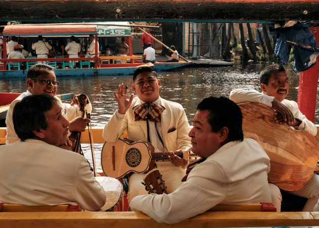 Mariachi band on boat in river in Mexico