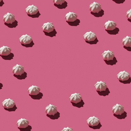 Pattern of meringues on pink background