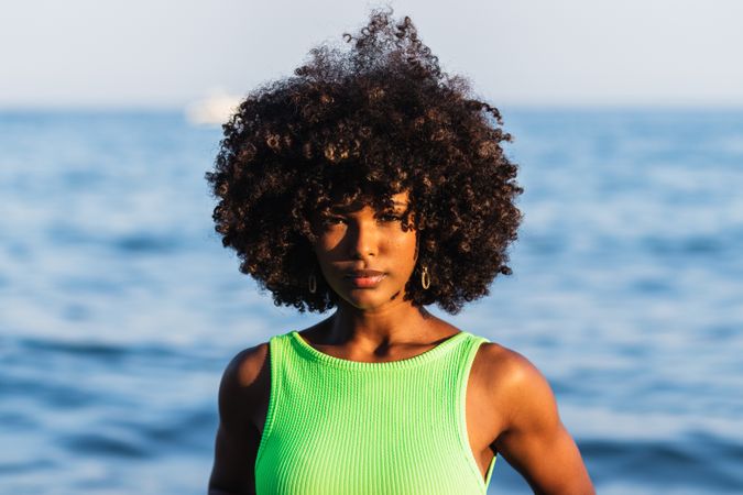 Dreamy Black woman standing in sea during summer vacation